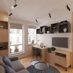 Przytulny salon w bloku z kącikiem do pracy przy oknie, wygodną kanapą i półkami na książki.