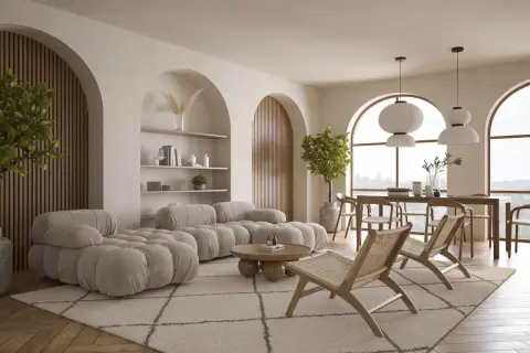 Miękka sofa w kolorze kremowym i plecione krzesła tworzą przytulną przestrzeń.