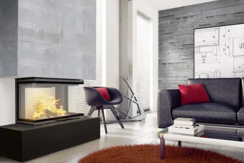 Nowoczesny salon z betonową ścianą i kominkiem. Zastanawiasz się, czym obłożyć kominek w salonie? Tutaj betonowa obudowa idealnie komponuje się z wnętrzem.