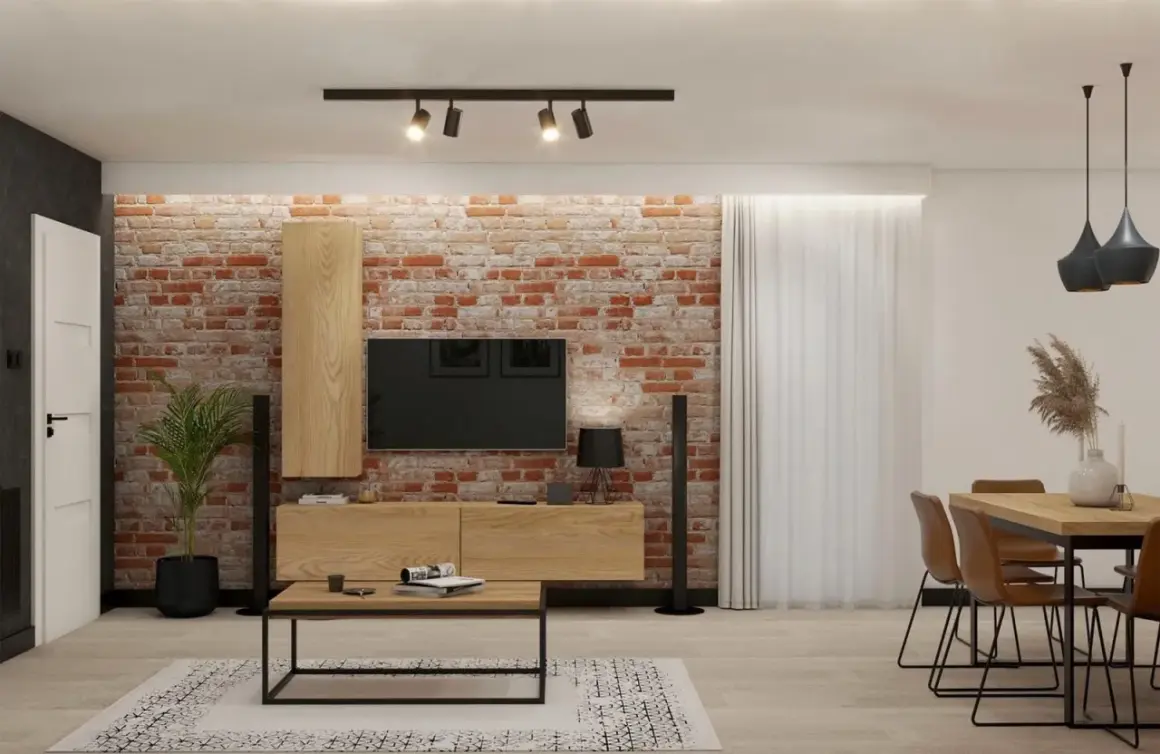 Nowoczesna aranżacja salonu w stylu loft z ceglaną ścianą, drewnianymi meblami i czarnymi dodatkami.